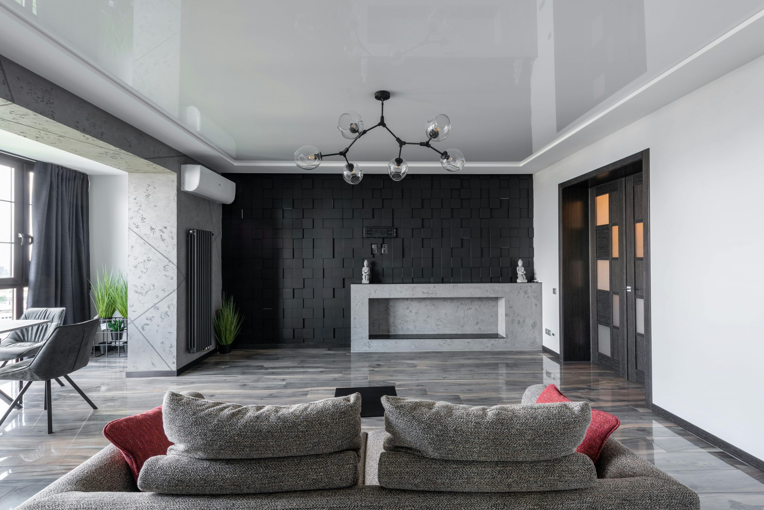 modern living room with white walls contrasted by a black accent wall